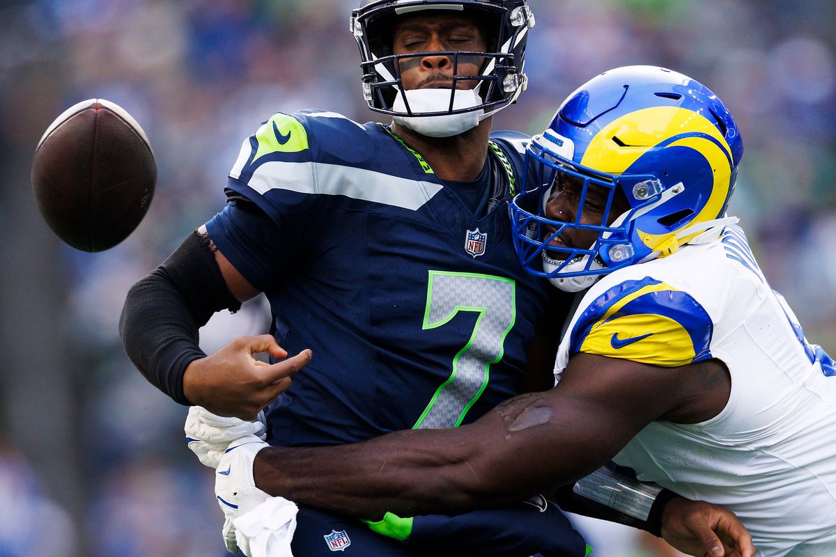 Geno Smith #7 of the Seattle Seahawks fumbles the ball during the first half against the Los Angeles Rams at Lumen Field on November 3, 2024 in Seattle, Washington. Geno Smith #7 of the Seattle Seahawks fumbles the ball during the first half against the Los Angeles Rams at Lumen Field on November 3, 2024 in Seattle, Washington.