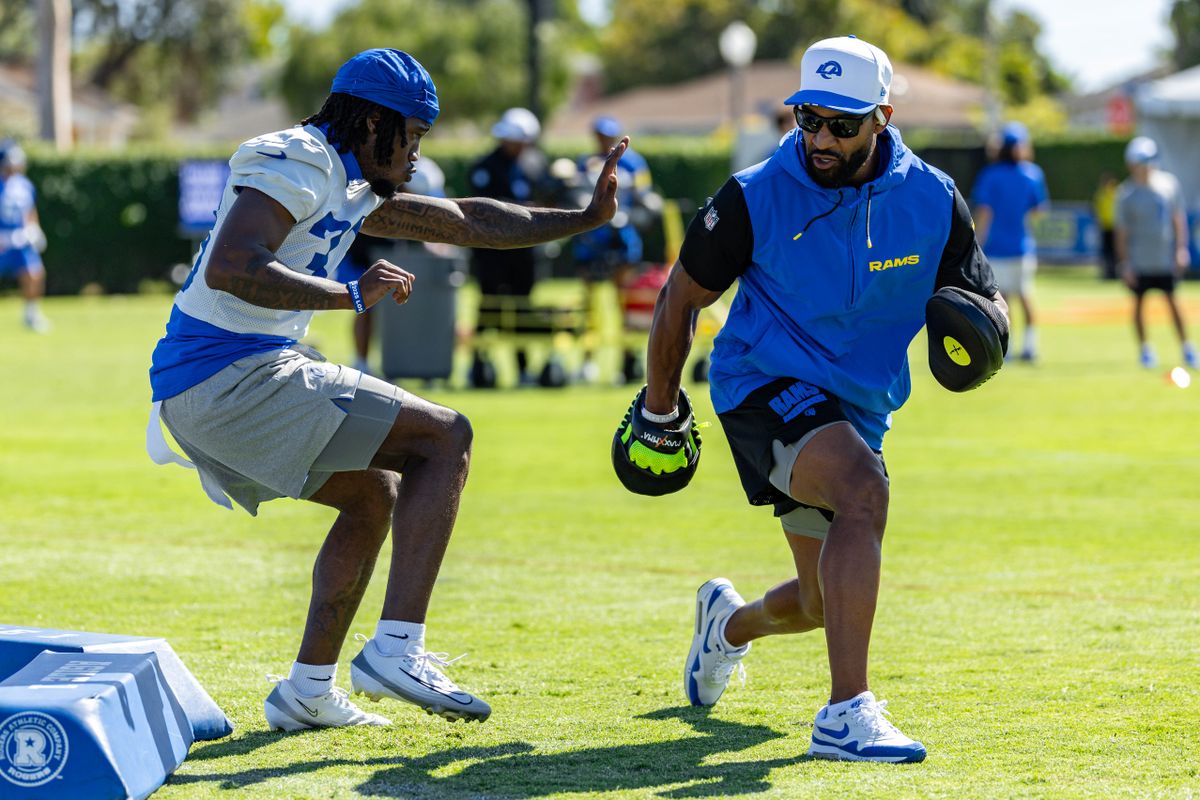 Los Angeles Rams cornerback Cam Lampkin (33) participates in a drill with Assistant Head Coach Aubrey Pleasant during training camp at Loyola Marymount University, Thursday July 24, 2025 in Los Angeles, Calif.