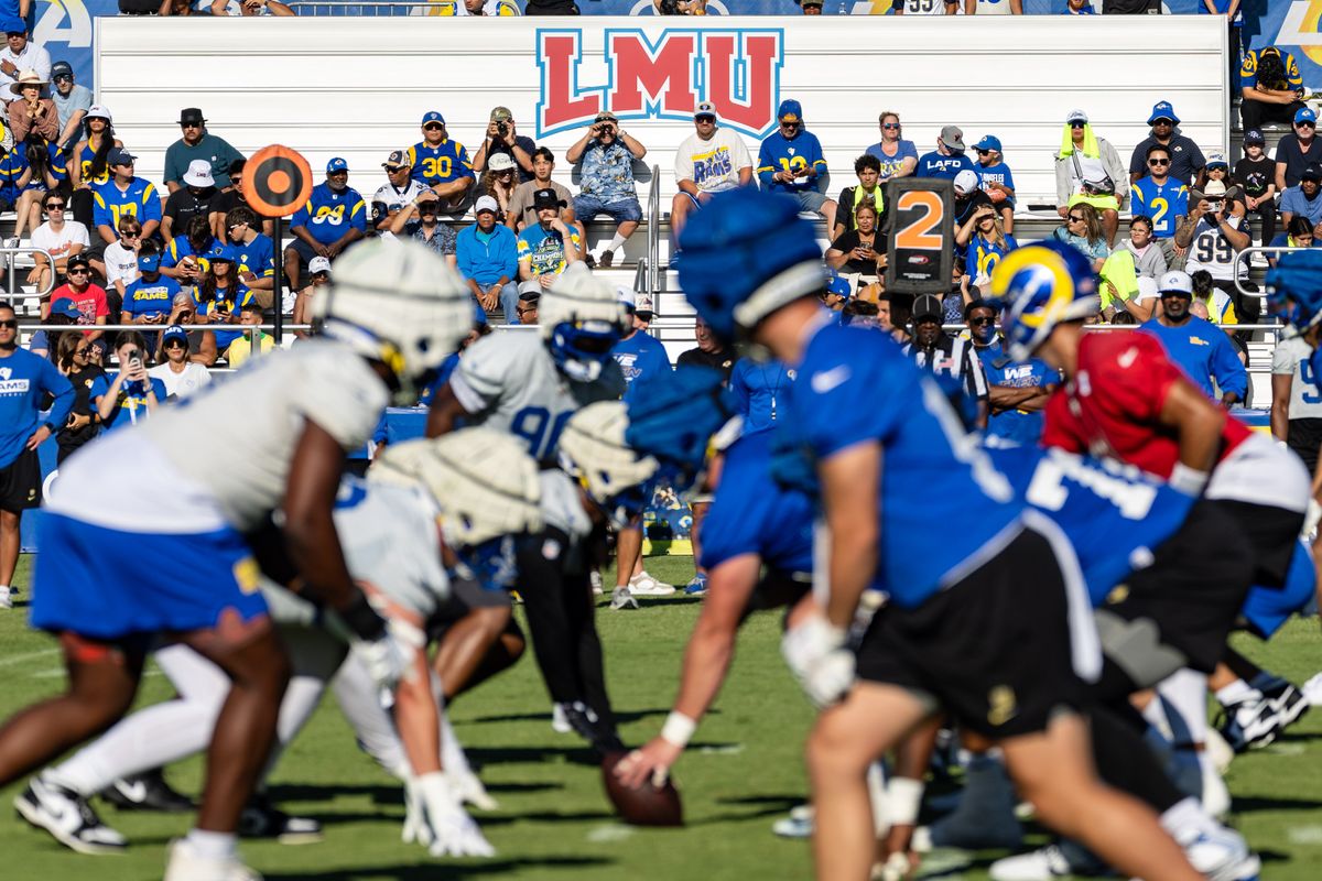 Los Angeles Rams players prepare to run a play during training camp at Loyola Marymount University, Thursday July 24, 2025 in Los Angeles, Calif.