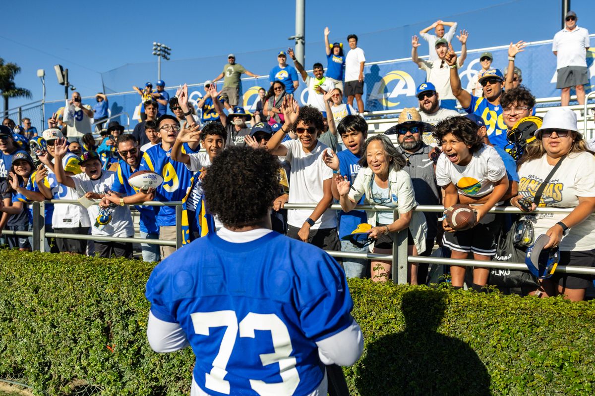 Los Angeles Rams guard Steve Avila (73) meets the fans after training camp at Loyola Marymount University, Thursday July 24, 2025 in Los Angeles, Calif.
