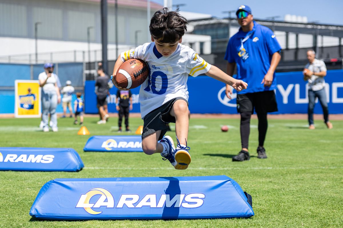 A young Los Angeles Rams fan takes part in a fan zone activity before training camp at Loyola Marymount University, Friday July 25, 2025 in Los Angeles, Calif.