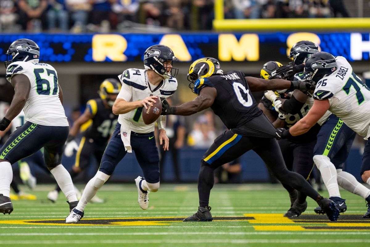 Seattle Seahawks quarterback, Sam Darnold (14) breaks a sack during an NFL football game against the Los Angeles Rams on November 16, 2025 in Los Angeles, CA.