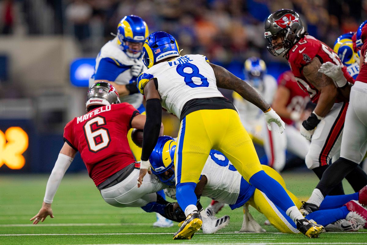 Los Angeles Rams defensive end, Kobie Turner (91) sacks Baker Mayfield (6) during an NFL football game against the Tampa Bay Buccaneers on November 23, 2025 in Los Angeles, CA.