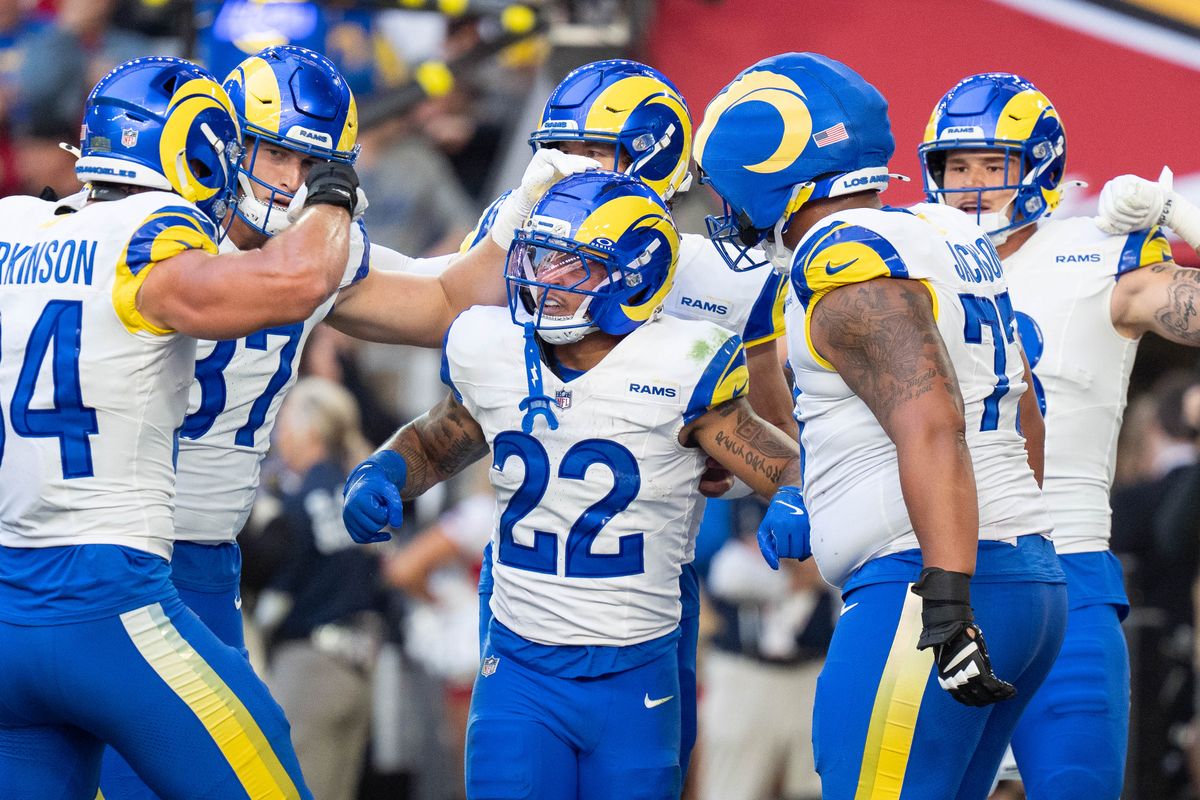Los Angeles Rams running back Blake Corum (22) celebrates a touchdown with teammates during an NFL football game against the Arizona Cardinals on Sunday, Dec. 7, 2025, in Glendale, AZ.