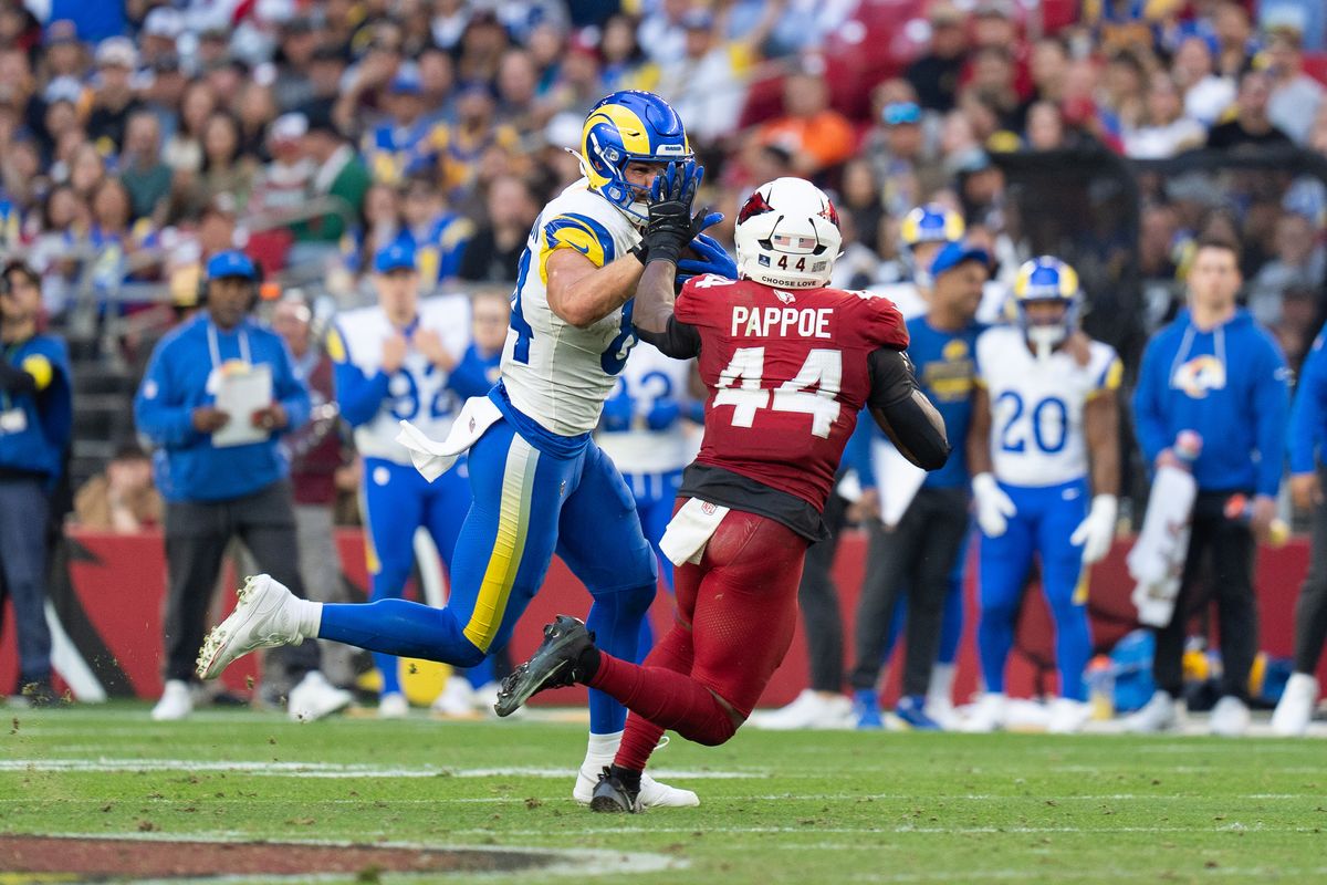 Los Angeles Rams tight end Colby Parkinson (84) fends off a defender during an NFL football game against the Arizona Cardinals on Sunday, Dec. 7, 2025, in Glendale, AZ.