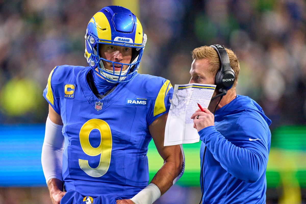 Los Angeles Rams quarterback Matthew Stafford (9) talks with  head coach Sean McVay during an NFL football game against the Seattle Seahawks, on Thursday December 18, 2025 in Seattle, Washington.
