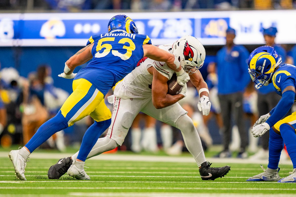 Los Angeles Rams linebacker, Nate Landman (53) tries to punch the ball out of tight end Trey McBride's (85) hands during an NFL football game against the Arizona Cardinals on January 4th, 2026 in Los Angeles, CA.
