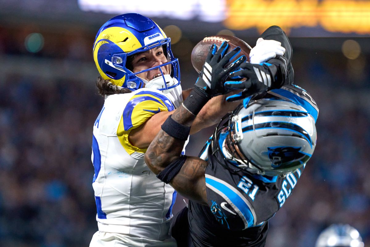 Los Angeles Rams wide receiver Puka Nacua #12 battles with Carolina Panthers safety Nick Scott #21 for the football during an NFL Wildcard football game against the Carolina Panthers, on Saturday, January 10, 2026 in Charlotte, North Carolina.             