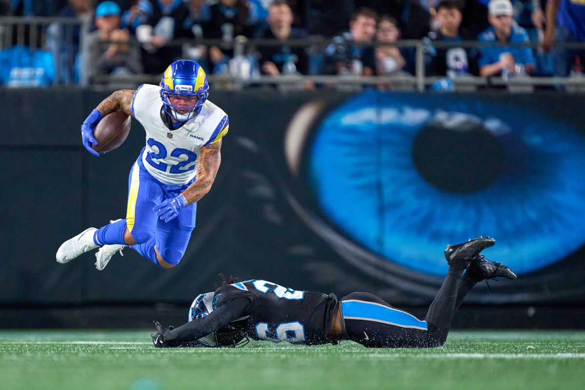 Los Angeles Rams running back Blake Corum #22 jumps over Carolina Panthers cornerback Chau Smith-Wade #26 during an NFL Wildcard football game against the Carolina Panthers, on Saturday, January 10, 2026 in Charlotte, North Carolina.             