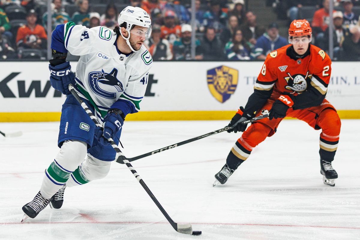 Paul Cotter #47 of the Vancouver Canucks looks to pass the puck during an NHL regular season game against the Anaheim Ducks on October 27, 2026 at Honda Center in Anaheim, California.