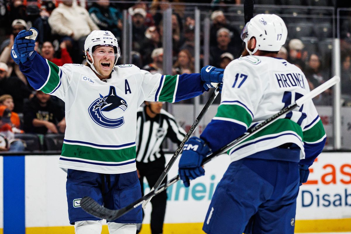 Brock Boeser #6 of the Vancouver Canucks celebrates after giving a game-winning assist to Filip Hronek #17 of the Vancouver Canucks during an NHL regular season game against the Anaheim Ducks on October 27, 2026 at Honda Center in Anaheim, California.