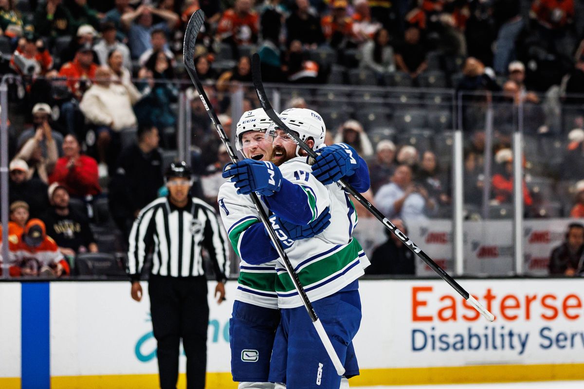 Filip Hronek #17 of the Vancouver Canucks celebrates with Brock Boeser #6 of the Vancouver Canucks after scoring the game-winning overtime goal during an NHL regular season game against the Anaheim Ducks on October 27, 2026 at Honda Center in Anaheim, California.