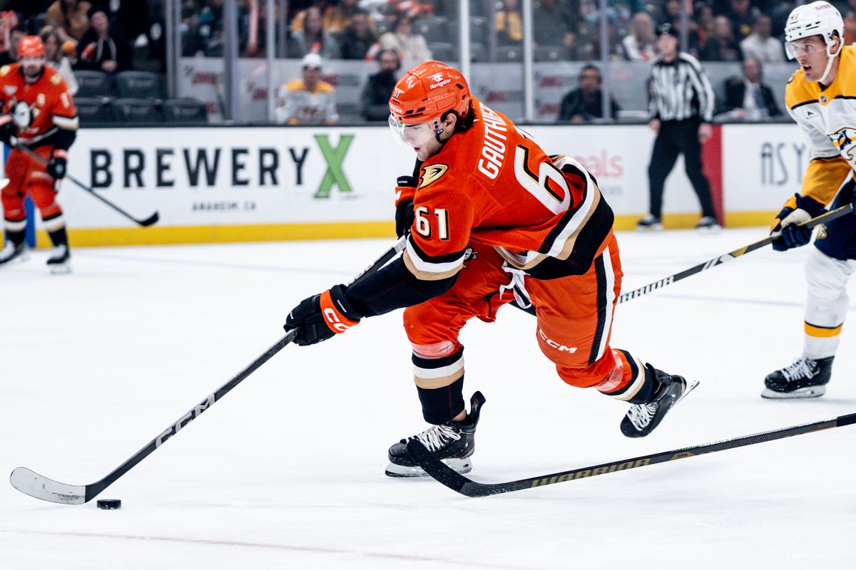 Anaheim Ducks LW Cutter Gauthier (61) skates through two defenders with the puck in a game against the Nashville Predators on January 25, 2025 at the Honda Center in Anaheim, CA.