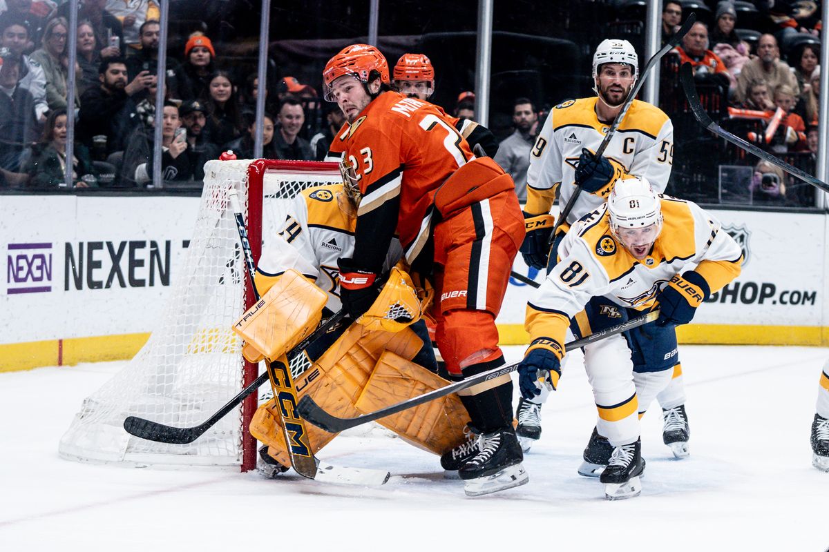 Anaheim Ducks C Mason Mctavish (23) gets shoved into the goalie in a game against the Nashville Predators on January 25, 2025 at the Honda Center in Anaheim, CA.