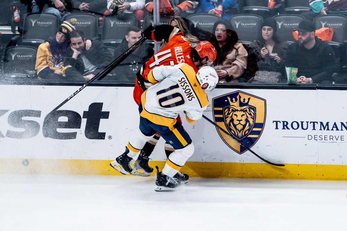 Anaheim Ducks D Drew Helleson (43) fights the defender for the puck in a game against the Nashville Predators on January 25, 2025 at the Honda Center in Anaheim, CA.