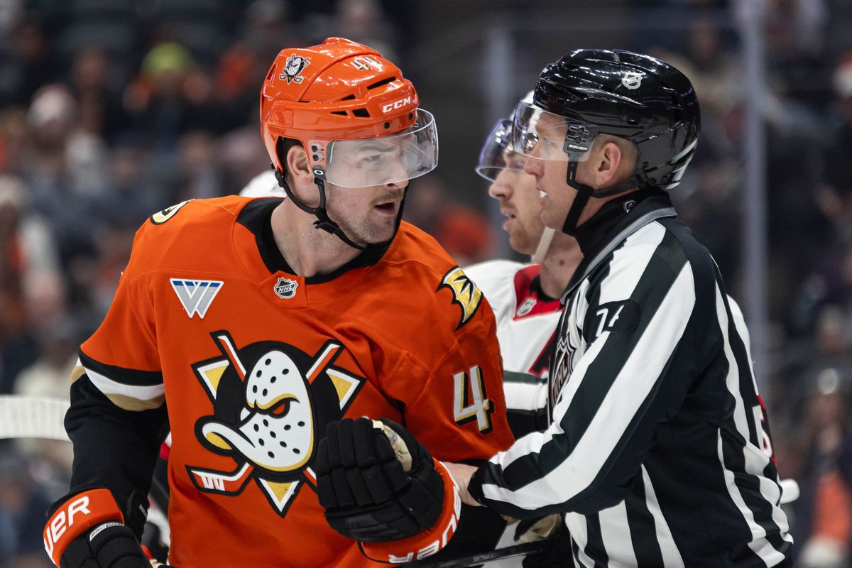 Anaheim Ducks L Ross Johnston (44) gets held back by the referee during an NHL game against the Ottawa Senators on November 20, 2025 in Anaheim, Calif.
