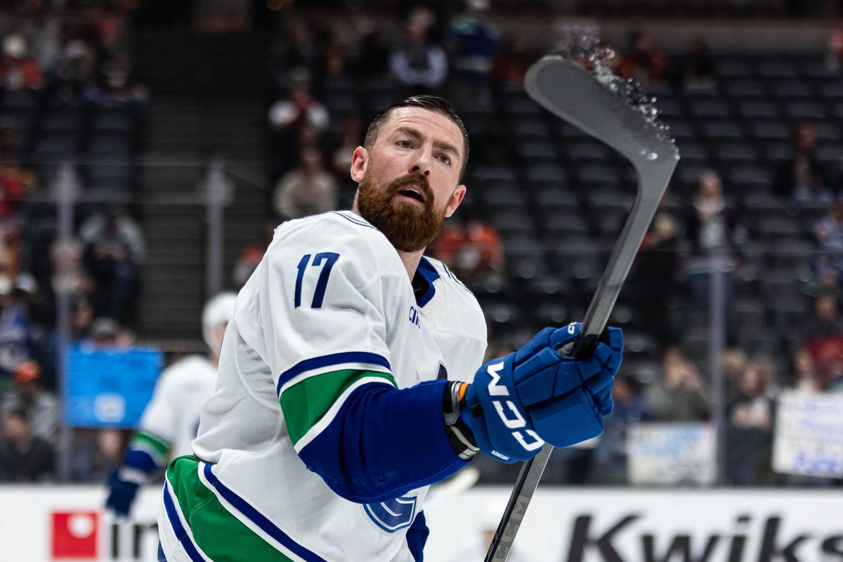 Vancouver Canucks defense Filip Hronek (17) tosses up the puck during pregame in an NHL game against the Anaheim Ducks on November 26, 2025 in Anaheim, Calif.
