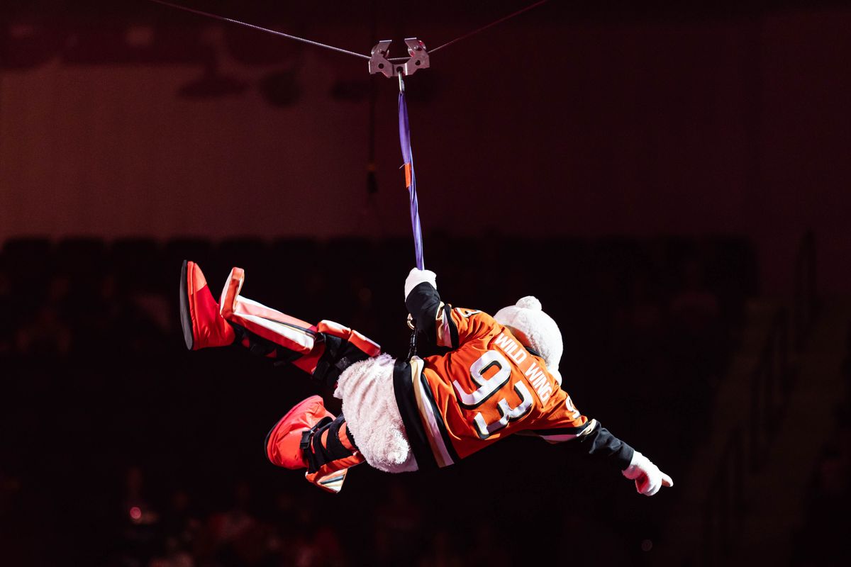 Anaheim Ducks' mascot Wild Wing rides a zipline during pregame in an NHL game against the Vancouver Canucks on November 26, 2025 in Anaheim, Calif.