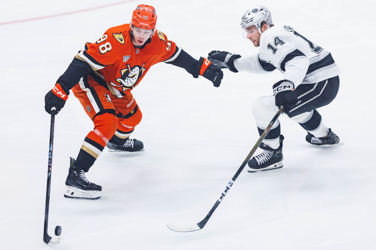 Anaheim Ducks defense Pavel Mintyukov (98) defends the puck from Los Angeles Kings right wing Alex Laferriere (14)  during an NHL game against the Los Angeles Kings on November 28, 2025 in Anaheim, Calif.