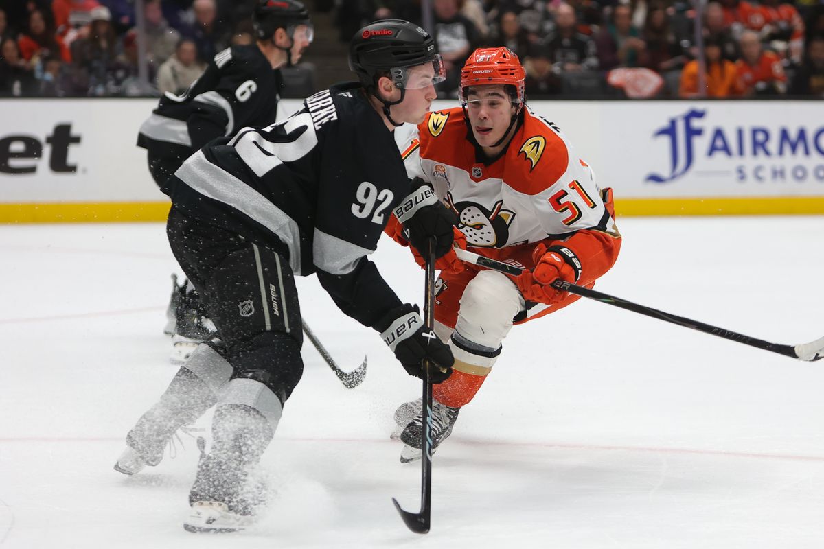 Los Angeles Kings defenseman Brandt Clarke (92) and Anaheim Ducks defenseman Olen Zellweger (51) collide during an NHL game on January 17, 2026 in Anaheim, CA.