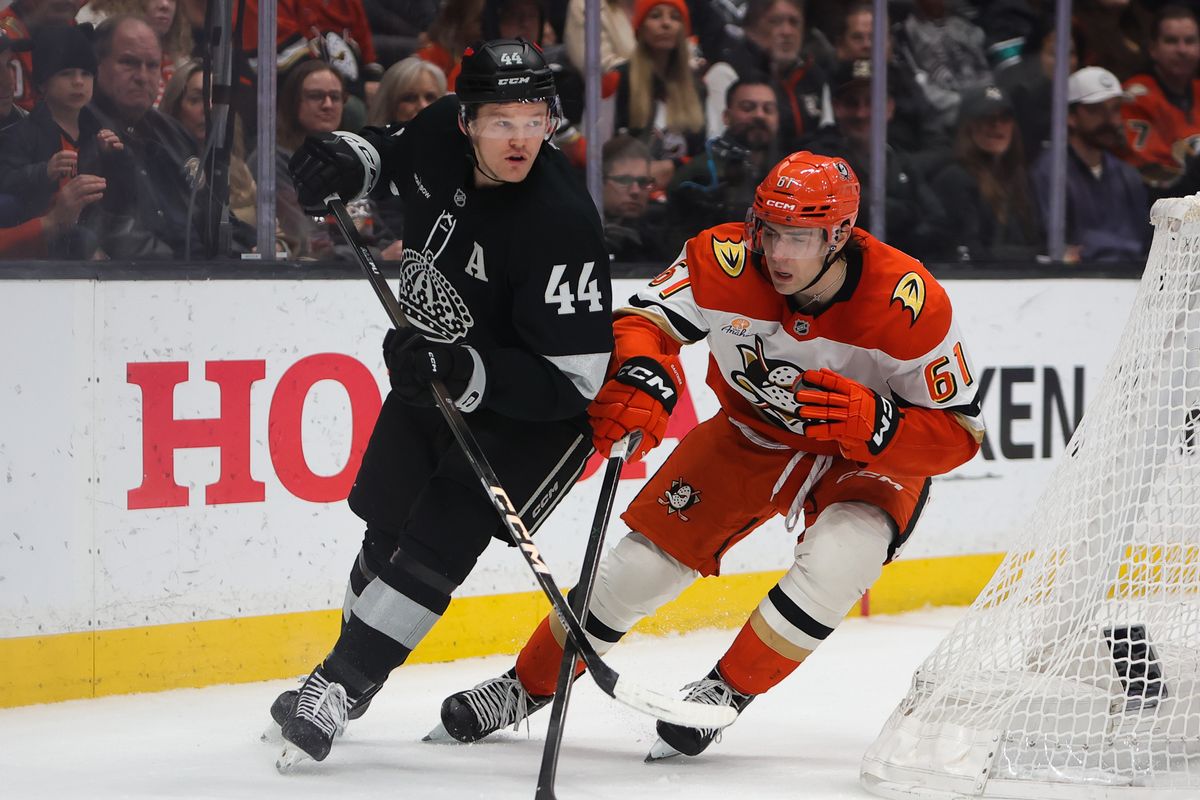Los Angeles Kings defenseman Mikey Anderson (44) and Anaheim Ducks left wing Cutter Gauthier (61) chase after the puck during an NHL game against on January 17, 2026 in Anaheim, CA.
