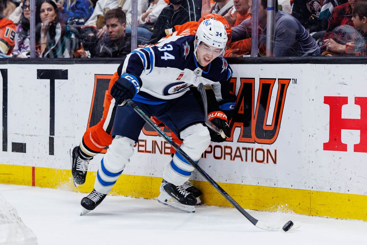 Winnipeg Jets defenseman Ville Heinola (34) defends the puck during an NHL match against the Anaheim Ducks on February 27, 2026 in Anaheim, California.