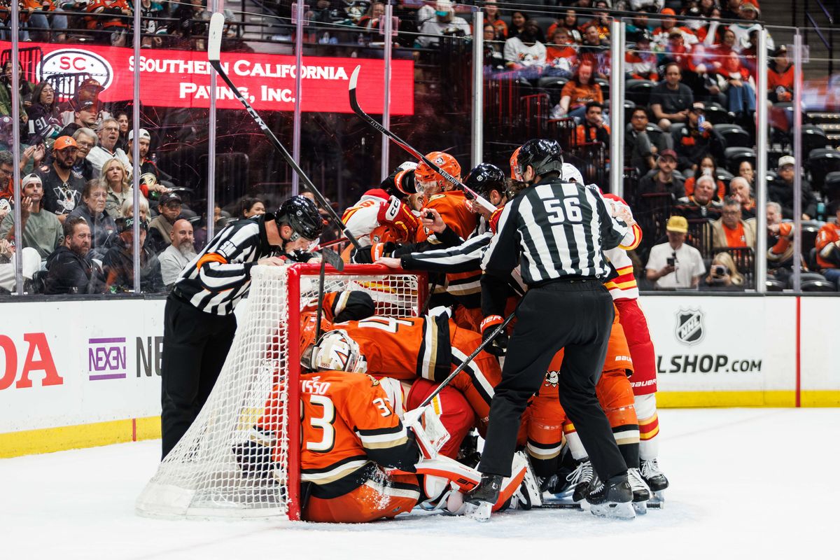 Anaheim Ducks dog pile in goal during an NHL hockey game against the Calgary Flames, Saturday April 4, 2026 in Anaheim, Calif.