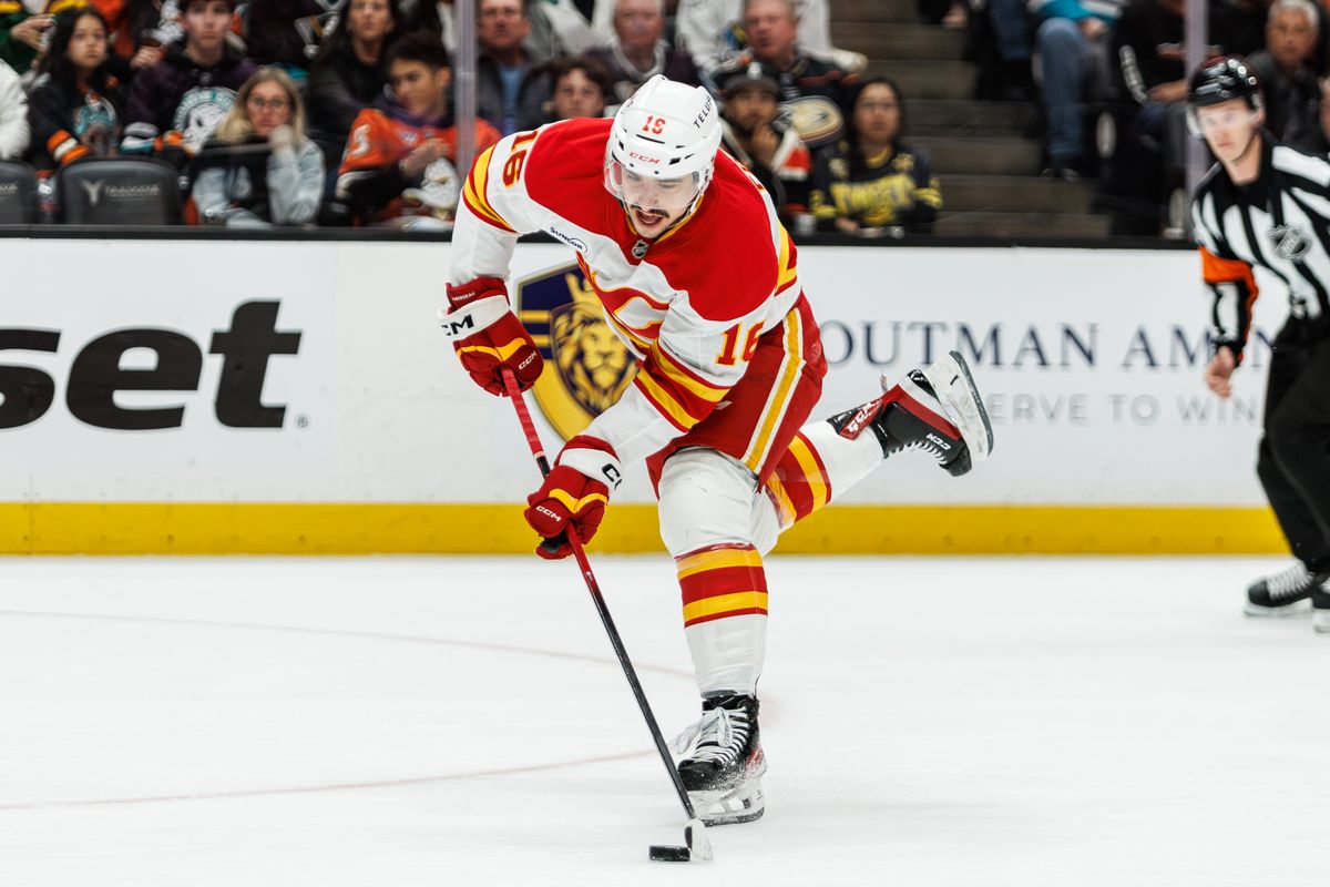 Calgary Flames center Morgan Frost (16) takes a shot to score during an NHL hockey game against the Calgary Flames, Saturday April 4, 2026 in Anaheim, Calif.