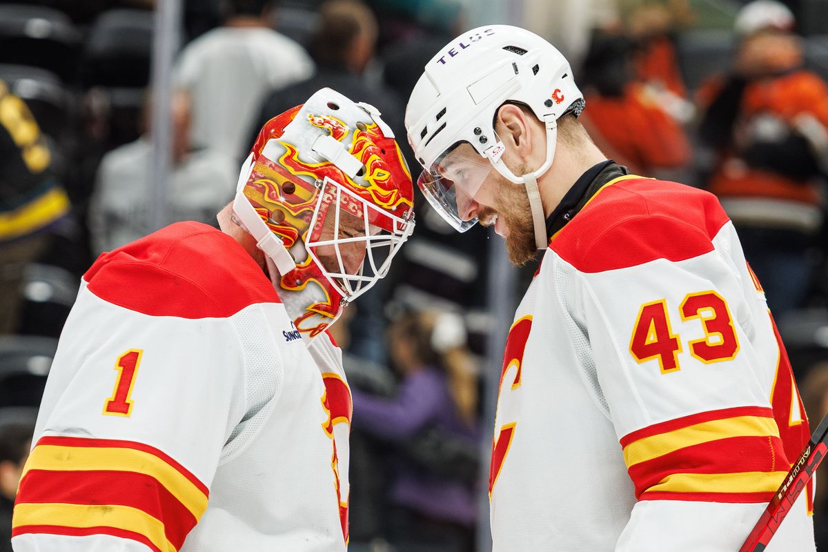 Calgary Flames goaltender Devin Cooley (1) and Calgary Flames right wing Adam Klapka (43) celebrate the win over the Anaheim Ducks after an NHL hockey game against the Anaheim Ducks, Saturday April 4, 2026 in Anaheim, Calif.