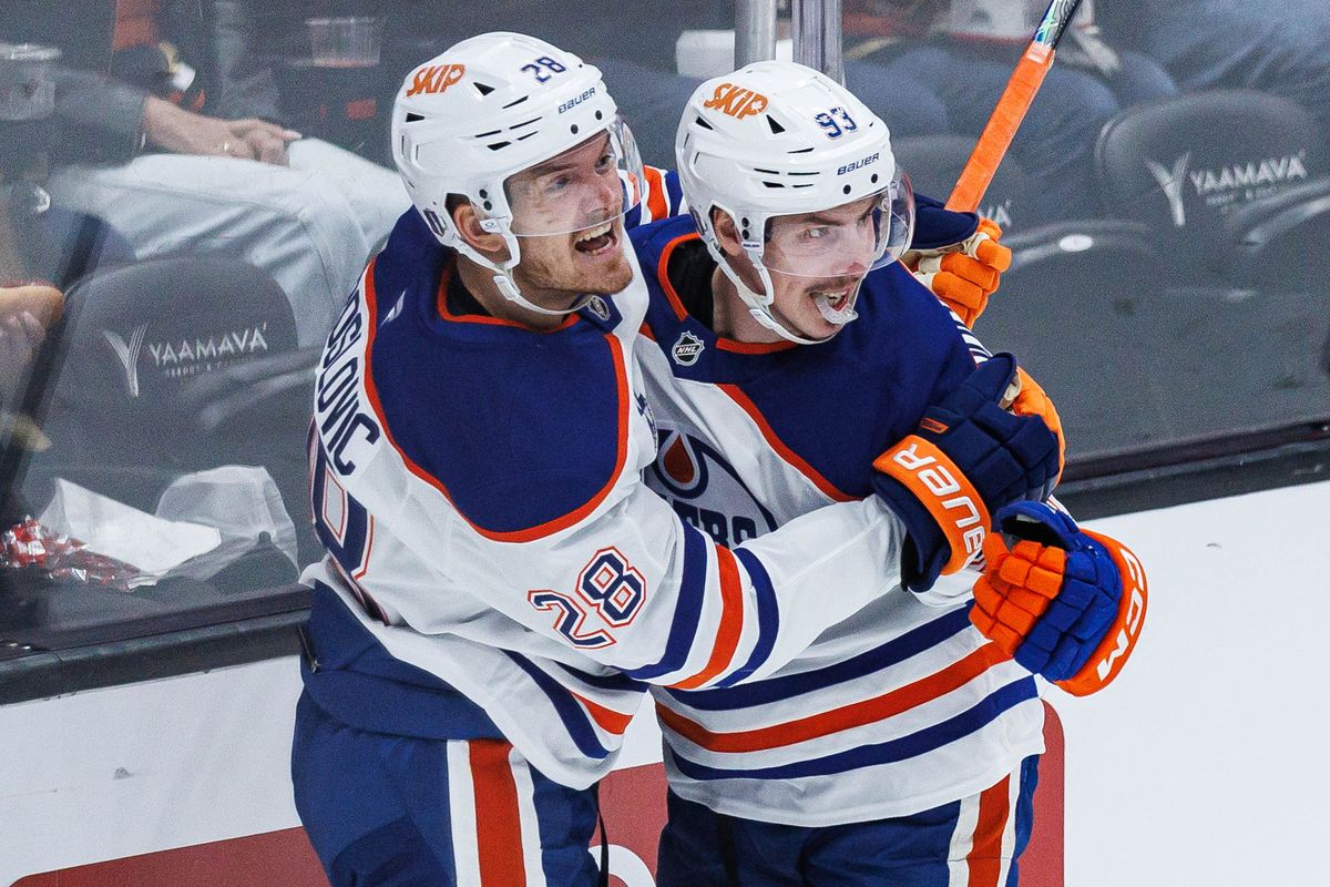 Ryan Nugent-Hopkins #93 (right) of the Edmonton Oilers celebrates with Jack Roslovic #28 (left) after scoring a goal during an NHL Playoffs game against the Anaheim Ducks on April 24, 2026 at Honda Center in Anaheim, California.