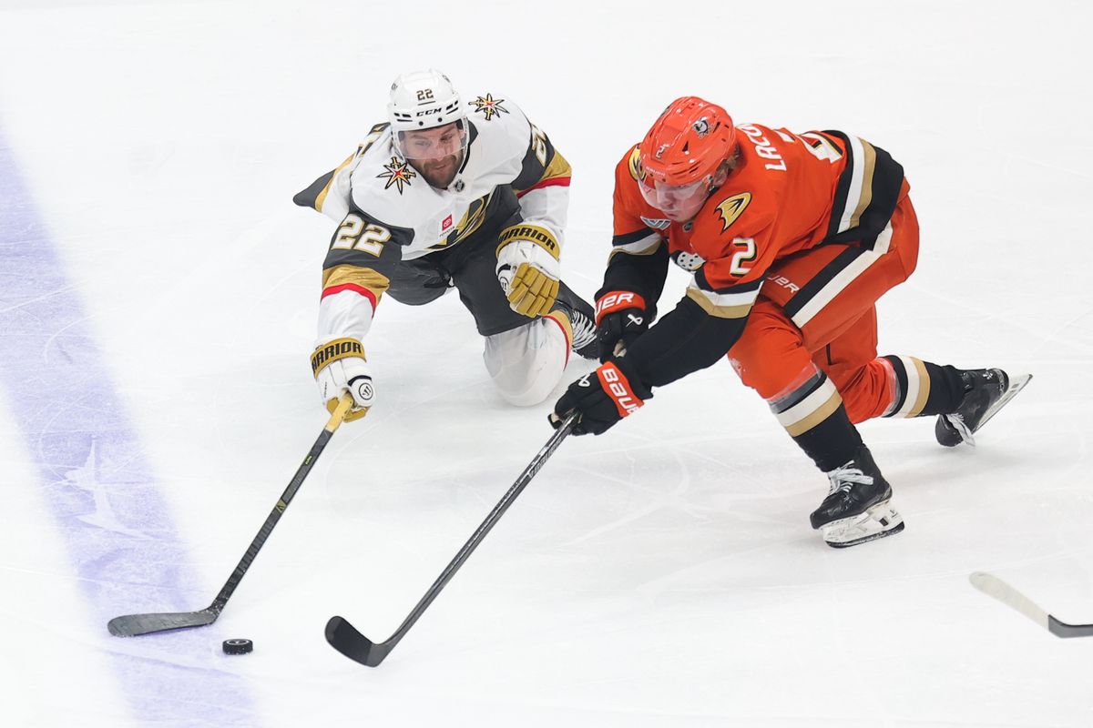 Anaheim Ducks defenseman Jackson LaCombe (2) and Las Vegas Golden Knights right wing Cole Smith (22) fight for the puck during a Stanley Cup Playoff game against on May 14, 2026 in Anaheim, CA.