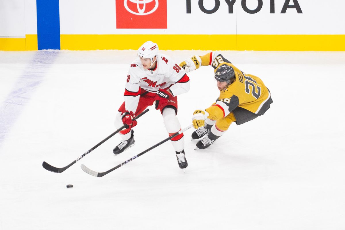 Carolina Hurricanes Center Martin Necas (88) keeps the puck away from Las Vegas Golden Knights Center Brett Howden (21) during an NHL game between the Las Vegas Golden Knights and the Carolina Hurricanes, Monday November 11 2024 in Las Vegas, Nev.