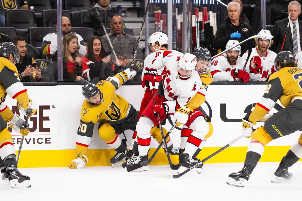 Las Vegas Golden Knights and Carolina Hurricanes players crowd by the boards and search for the puck during an NHL game between the Las Vegas Golden Knights and the Carolina Hurricanes, Monday November 11, 2024 in Las Vegas, Nev.