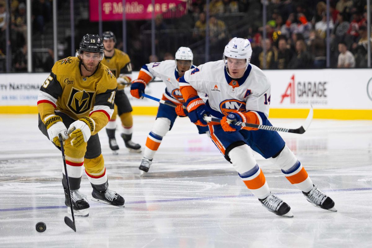  New York Islanders center Bo Horvat (14) and Las Vegas Golden Knights defenseman Noah Haniffin (15) chase after a dumped puck during a NHL game between the Las Vegas Golden Knights and the New York Islanders, Thursday January 9, 2025 in Las Vegas, Nev.
