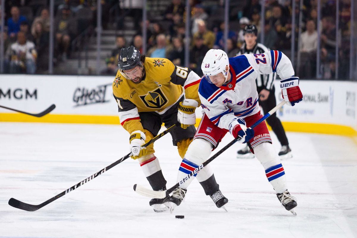 Las Vegas Golden Knights right wing Mark Stone (61) and New York Rangers defenseman Adam Fox (23) fight over the puck at center ice during a NHL game between the Las Vegas Golden Knights and the New York Rangers, Saturday January 11, 2025 in Las Vegas, Nev.