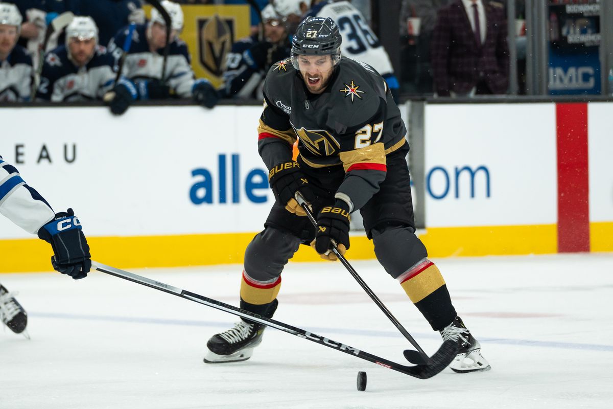 Vegas Golden Knights defenseman Shea Theodore (27) attempts to maintain control of the puck during third period of NHL game against Winnipeg Jets on Thursday April 3, 2025 in Las Vegas.