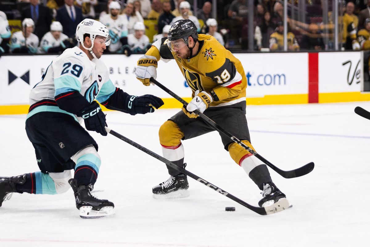 Las Vegas Golden Knights right-wing Riley Smith (19) tries to skate past Seattle Kraken defenseman Vince Dunn (29) during a NHL game between the Las Vegas Golden Knights and the Seattle Kraken, Thursday April 10, 2025 in Las Vegas, Nev.