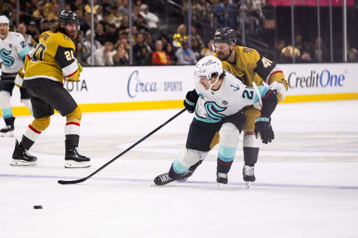  Seattle Kraken center Mikey Eyssimont (21) skates into the offensive zone as Las Vegas Golden Knights center Tomas Hertl (48) attempts to poke the puck during a NHL game between the Las Vegas Golden Knights and the Seattle Kraken, Thursday April 10, 2025 in Las Vegas, Nev.
