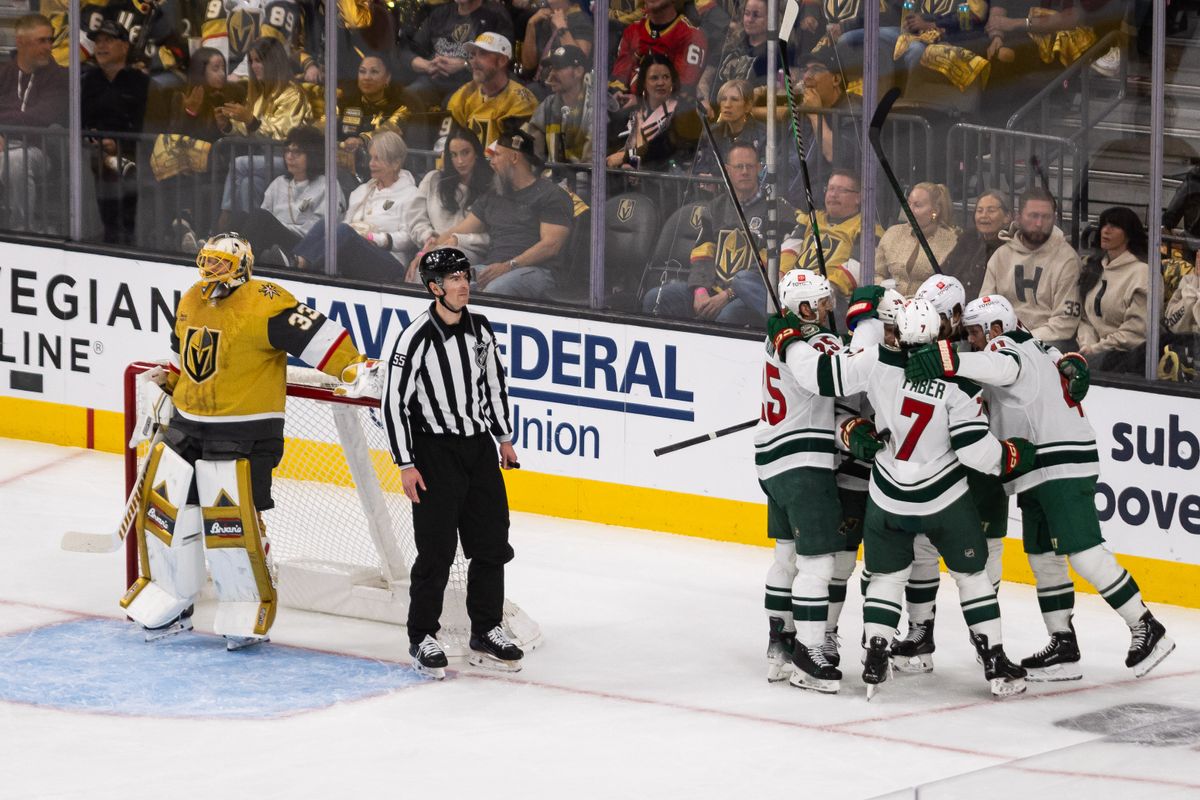 Minnesota Wild players embrace in celebration after scoring a goal as Las Vegas Golden Knights goaltender Adin Hill (33) looks at the replay on the jumbotron during a NHL playoff game between the Las Vegas Golden Knights and the Minnesota Wild, Tuesday April 22, 2025 in Las Vegas, Nev. Minnesota Wild players embrace in celebration after scoring a goal as Las Vegas Golden Knights goaltender Adin Hill (33) looks at the replay on the jumbotron during a NHL playoff game between the Las Vegas Golden Knights and the Minnesota Wild, Tuesday April 22, 2025 in Las Vegas, Nev.