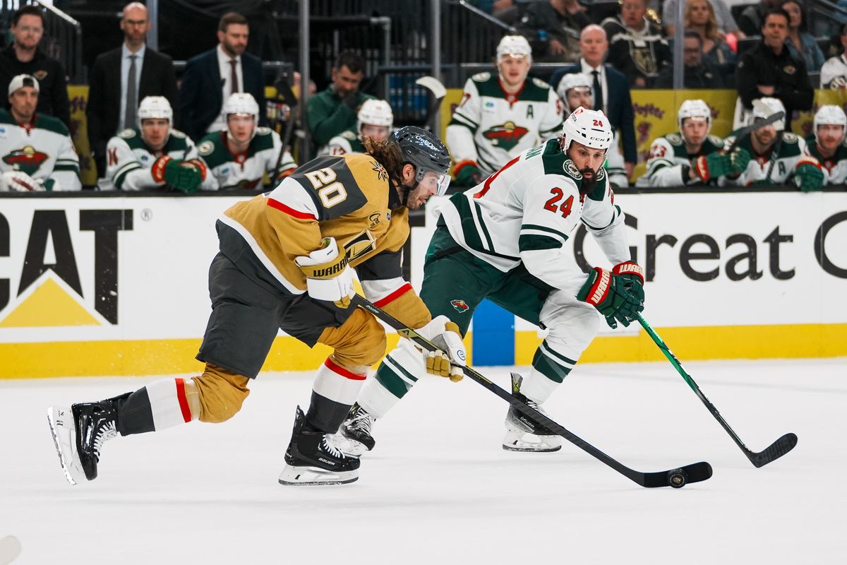 Vegas Golden Knights left wing Brandon Saad (20) takes the puck down the ice followed by Minnesota defenseman Zach Bogosian (24) during second period of NHL playoff game against Minnesota Wild on Tuesday April 29, 2025 in Las Vegas.