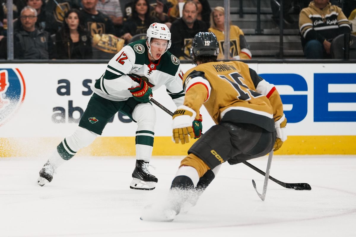 Minnesota Wild left wing Matt Boldy (12) attempts to escape Vegas Golden Knights defenseman Noah Hanifin (15) during third period of NHL playoff game against Vegas Golden Knights on Tuesday April 29, 2025 in Las Vegas.