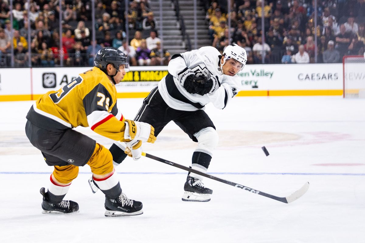 Los Angeles Kings forward Trevor Moore (12) dumps the puck into the offensive zone during a preseason NHL game between the Las Vegas Golden Knights and the Los Angeles Kings, Tuesday September 23, 2025 in Las Vegas, Nev.
