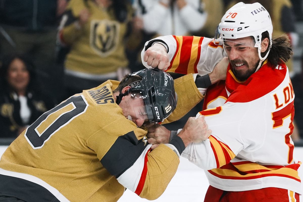 Vegas Golden Knights center Colton Sissons (10) and Calgary Flames left wing Ryan Lomberg (70) fight during first period of NHL game against Calgary Flames  on Saturday, Oct. 18, 2025 at T-Mobile Arena in Las Vegas.