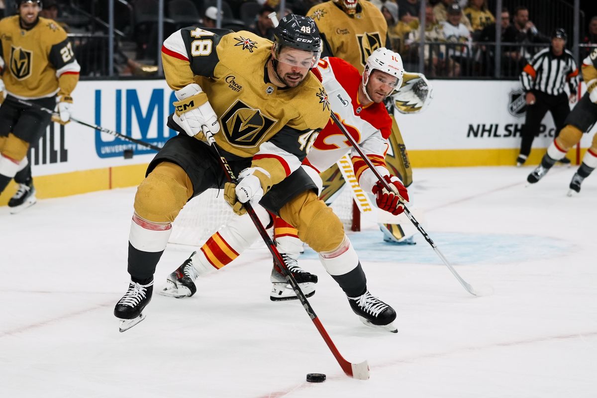 Vegas Golden Knights center Thomas Hertl (48) attempts to take the puck down the ice while Calgary Flamesleft wing Johnathan Huberdeau (10 scans the puck during second period of NHL game against Calgary Flames  on Saturday, Oct. 18, 2025 at T-Mobile Arena in Las Vegas.