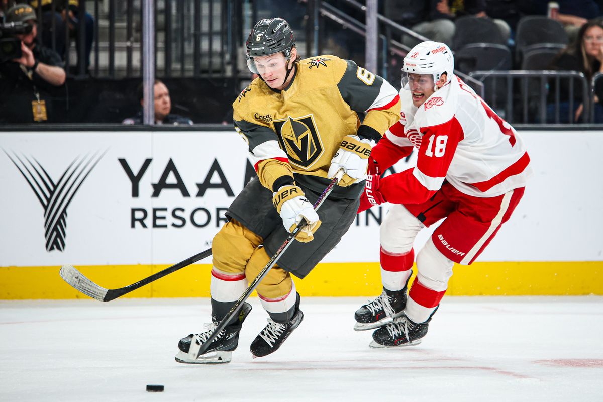 Vegas Golden Knights D Kaedan Korczak (6) skates with the puck defended by Detroit Red Wings C Andrew Copp (18) during an NHL game on Tuesday November 4, 2025, in Las Vegas, Nevada. 
