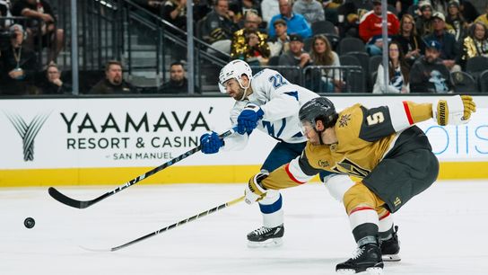 Tampa Bay Lightning center Brayden Point (21) passes the puck while Vegas Golden Knights defenseman Brayden McNabb and goalie Carl Windburn (30) defend the goal during second period of NHL game against Vegas Golden Knights on Tuesday, Nov. 6, 2025 at T-Mobile Arena in Las Vegas.