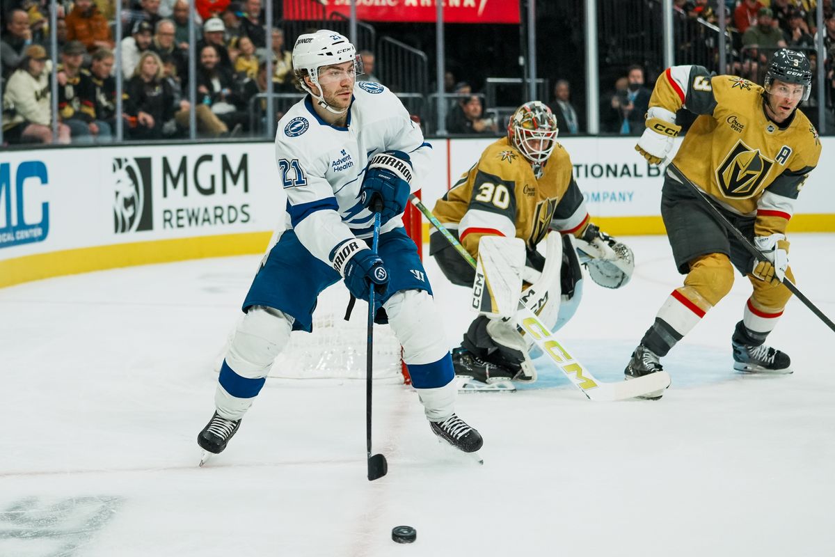 Tampa Bay Lightning center Brayden Point (21) passes the puck while Vegas Golden Knights defenseman Brayden McNabb and goalie Carl Windburn (30) defend the goal during second period of NHL game against Vegas Golden Knights on Tuesday, Nov. 6, 2025 at T-Mobile Arena in Las Vegas.