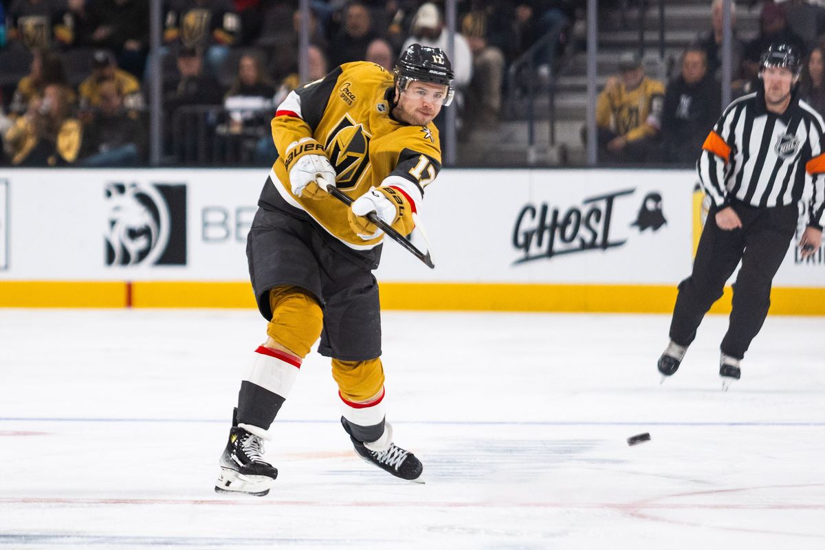 Vegas Golden Knights defenseman Ben Hutton (17) dumps the puck into the offensive zone during a NHL game between the Vegas Golden Knights and the Chicago Blackhawks, Tuesday December 2, 2025 in Las Vegas, Nev.