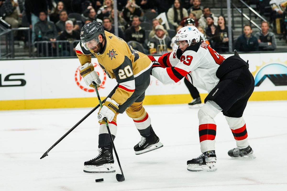 Vegas Golden Knights left wing Brandon Saad prepares to shoot the puck while pushed by Devils defensemen Luke Hughes (43) during second period of NHL game against New Jersey Devils on Wed., Dec. 17, 2025, at T-Mobile Arena in Las Vegas.