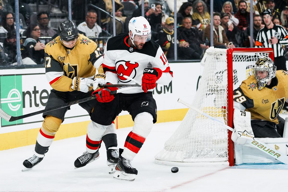Golden Knights defensemen Ben Hutton (17) tries to block Devils right wing Stefan Noesen (11) from scoring a goal while goalie Carter Hart (79) eyes the puck during third period of NHL game against New Jersey Devils on Wed., Dec. 17, 2025, at T-Mobile Arena in Las Vegas.